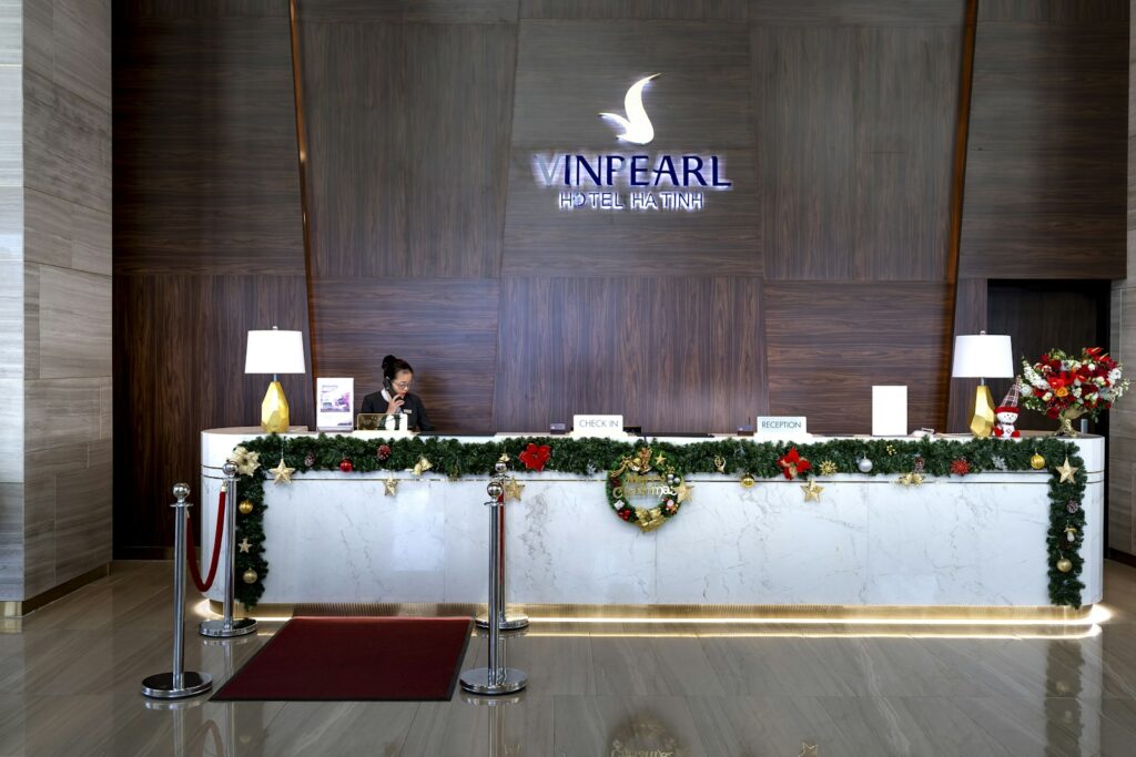 Guest speaking with a receptionist at a hotel front desk