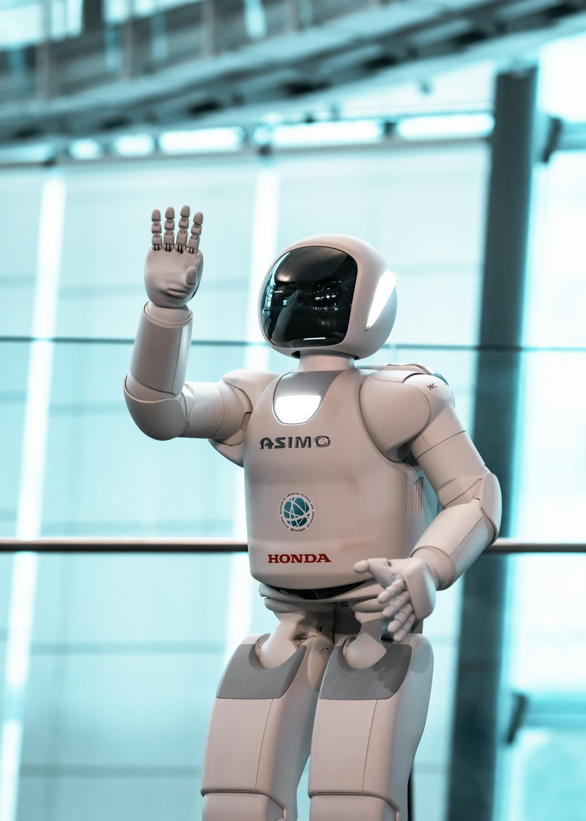 A white humanoid robot greeting visitors in a science museum